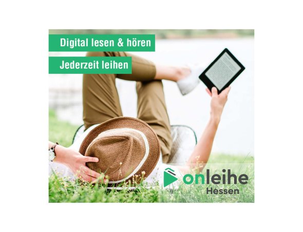 Mensch liegt lesend im Gras